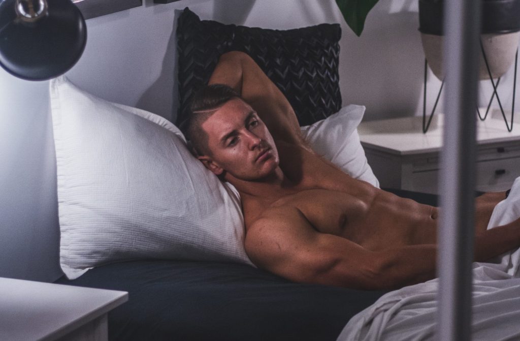 man in bed looking sexy